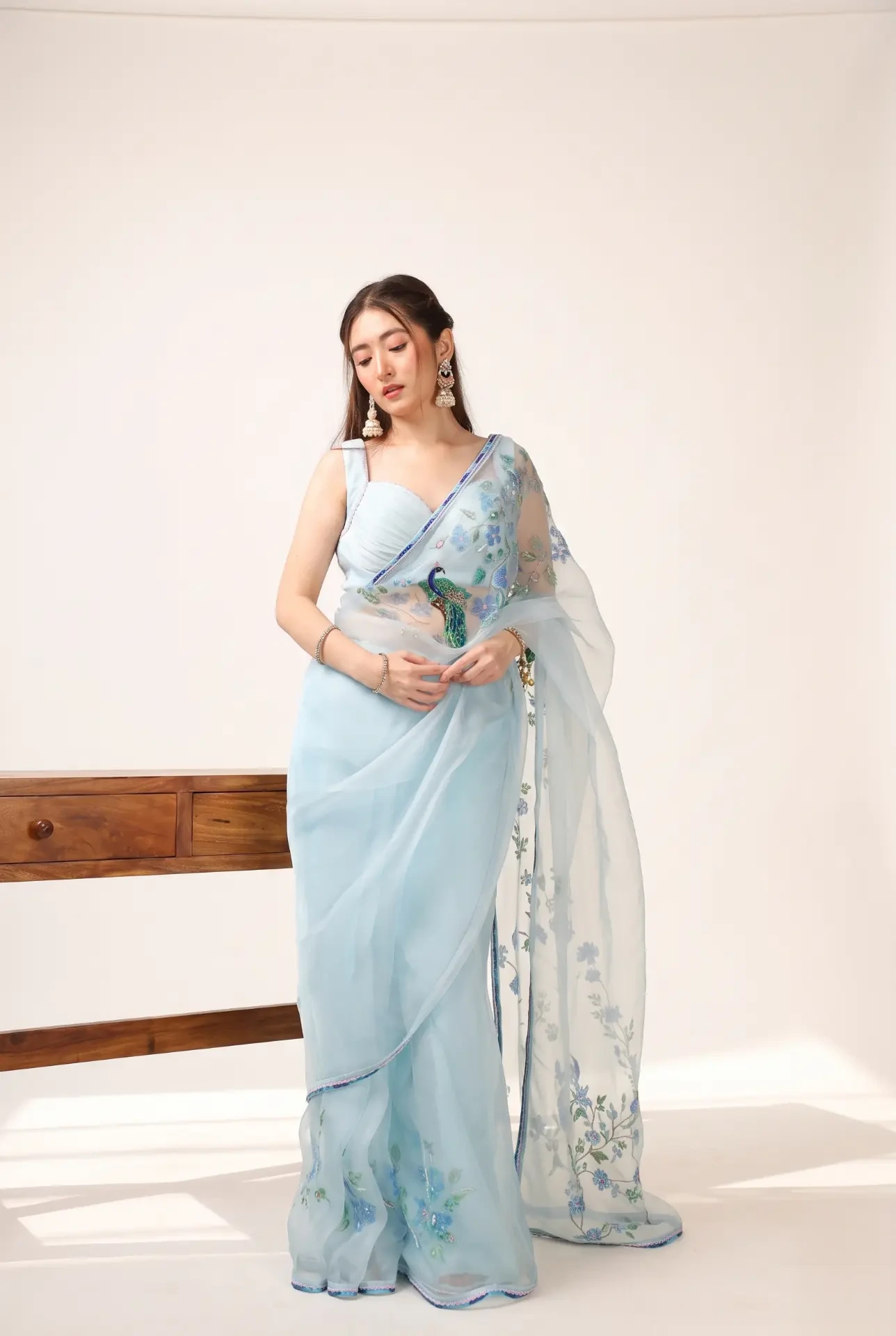 Mor Pankh — Hand-painted organza saree with peacock motifs, paired with a pleated blouse
